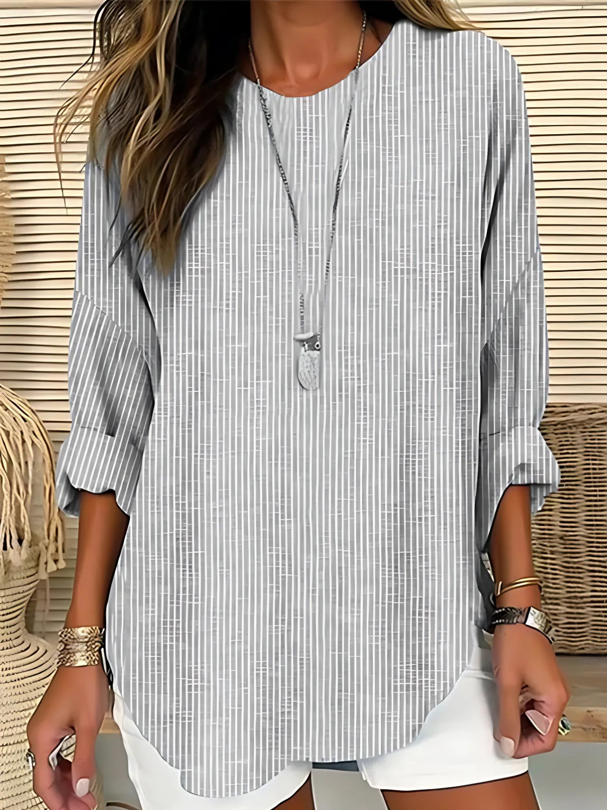 A women's long-sleeve blouse featuring vertical stripes, designed with an elegant and stylish look. 2