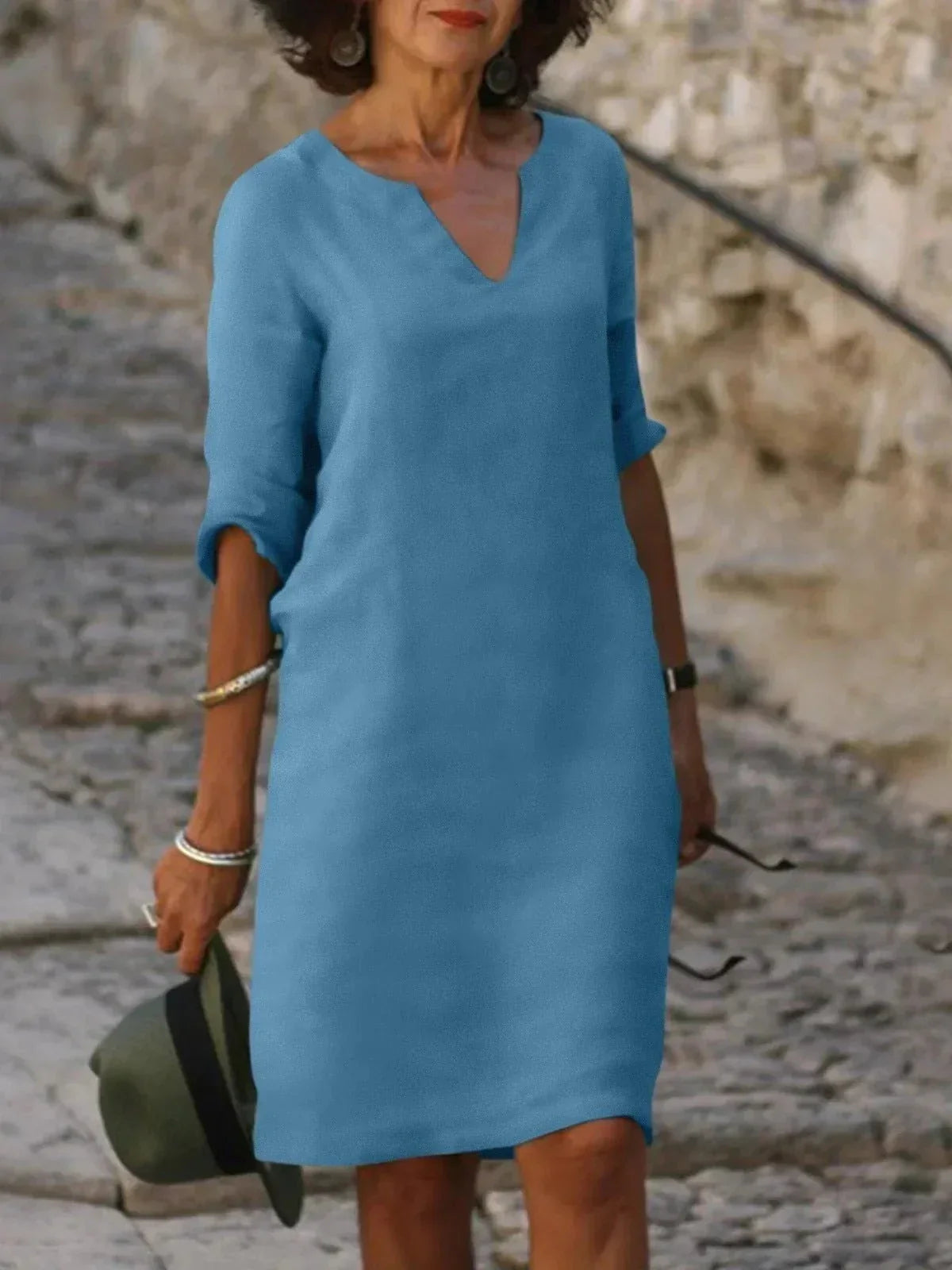 Women's black dress with three-quarter sleeves and a collar, featuring a simple and elegant design. 7