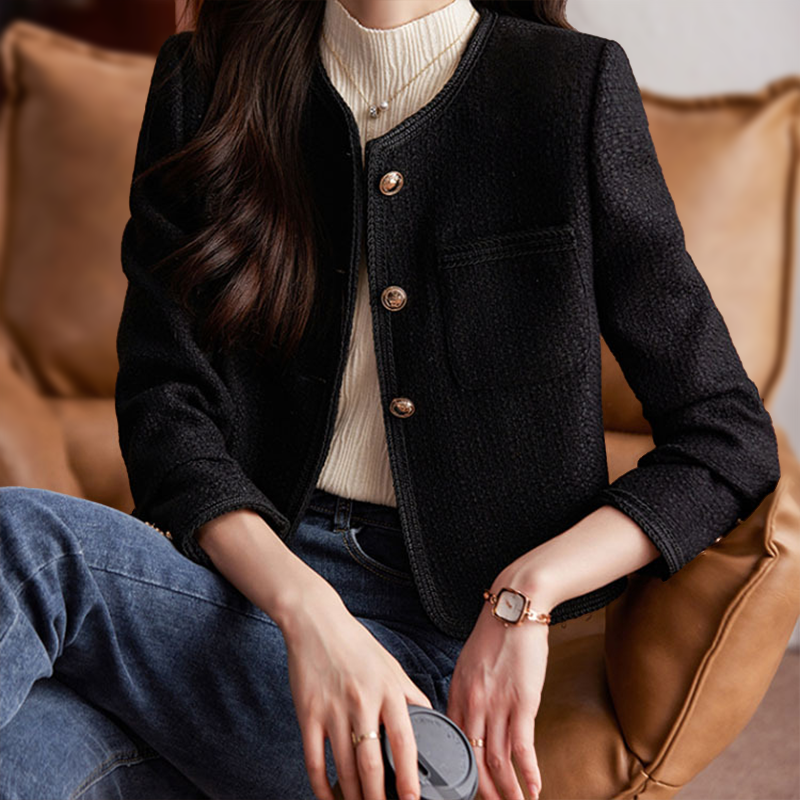 Short women's tweed blazer featuring a round neckline and metal buttons. 8