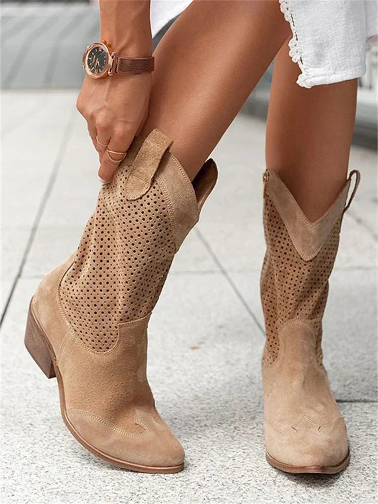 A pair of women's heeled cowboy boots featuring a cut-out design and a side zipper for easy wear. 5