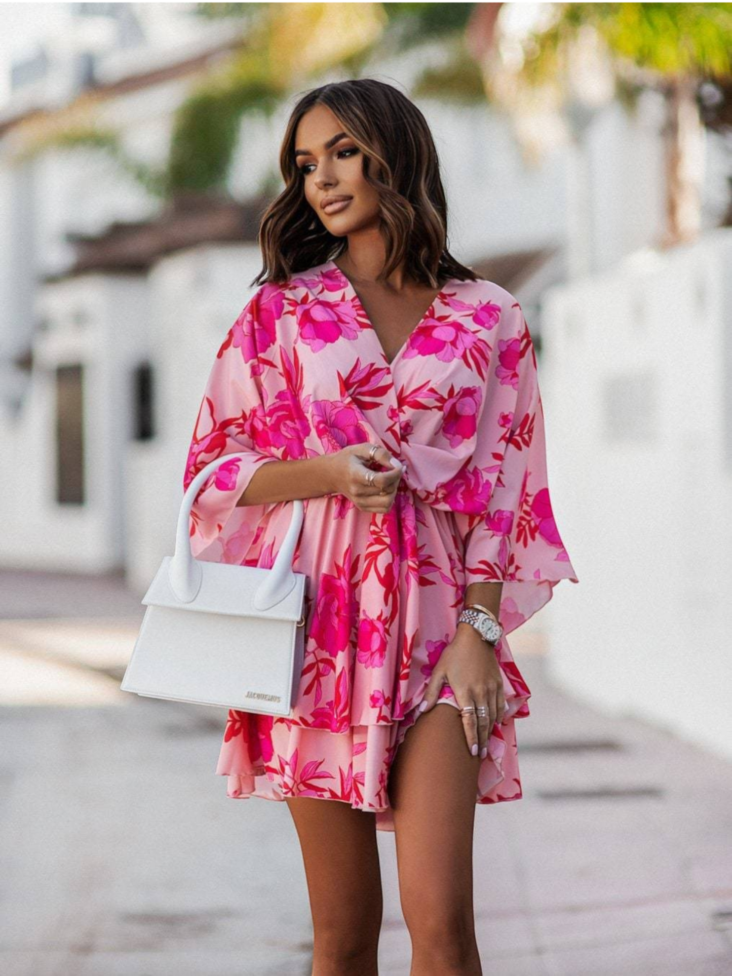 Women's mini dress featuring floral ruffles along the neckline and hem, designed with short sleeves and a flowy silhouette. 5