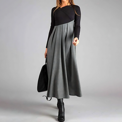 Maxi dress with long sleeves and a pleated bottom, designed for formal occasions like weddings. 0