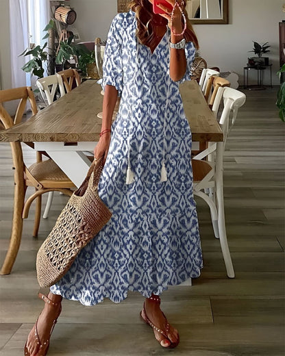 A bohemian style dress with a loose fit and playful patterns, designed for women. The dress features a flowing silhouette and a vibrant print, suitable for 0