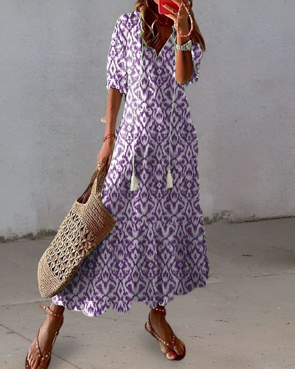 A bohemian style dress with a loose fit and playful patterns, designed for women. The dress features a flowing silhouette and a vibrant print, suitable for 2