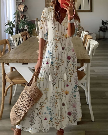 A bohemian style dress with a loose fit and playful patterns, designed for women. The dress features a flowing silhouette and a vibrant print, suitable for 6