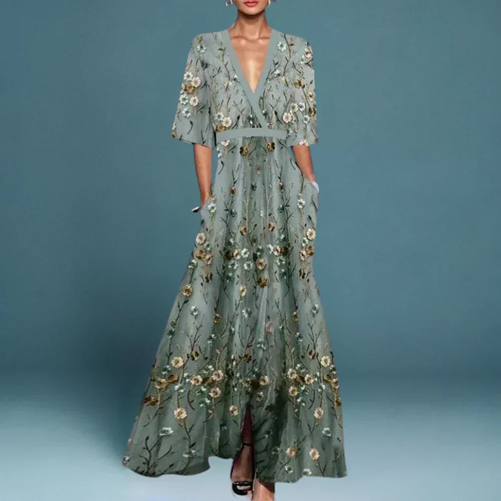 Maxi dress featuring a floral pattern and a flowing silhouette, designed for formal occasions such as weddings. 0