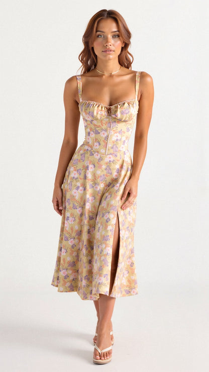 A woman wearing a midi dress with a fitted bodice and a flowing skirt, suitable for a wedding. The dress features a corset-style top and 0