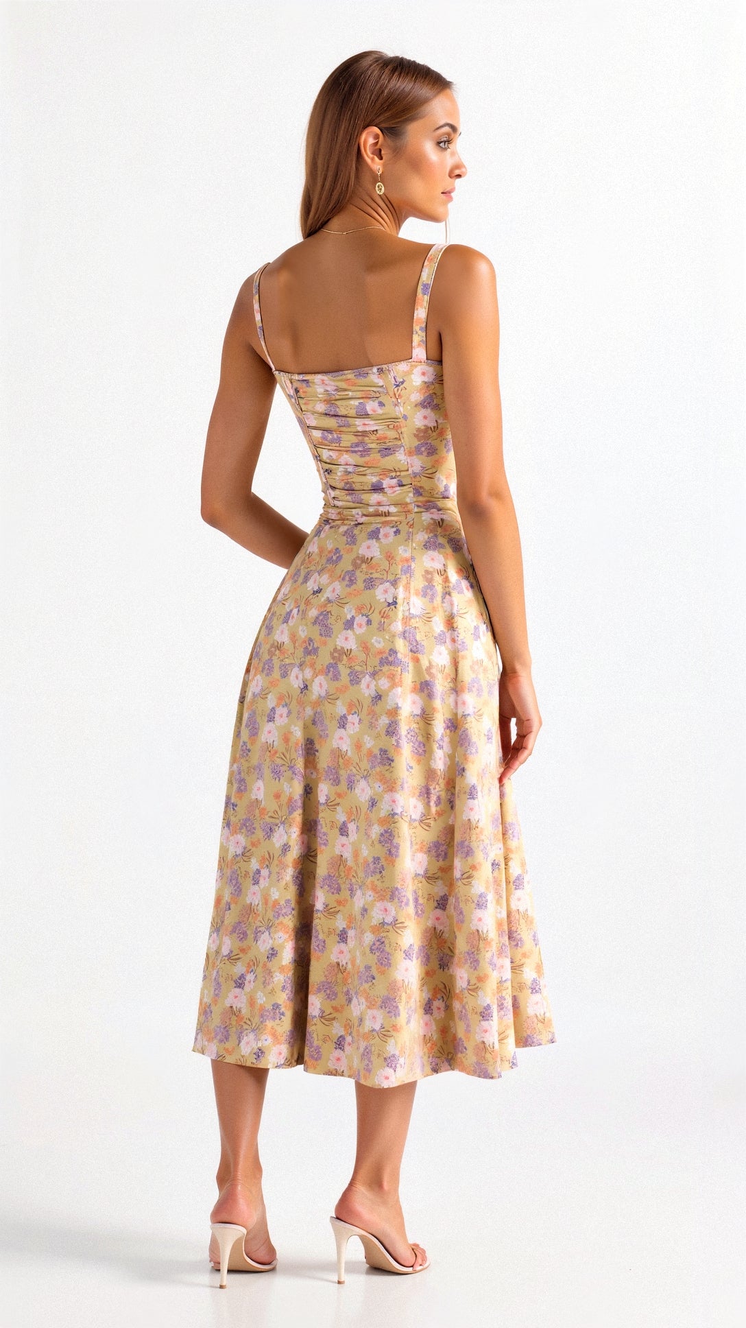 A woman wearing a midi dress with a fitted bodice and a flowing skirt, suitable for a wedding. The dress features a corset-style top and 1