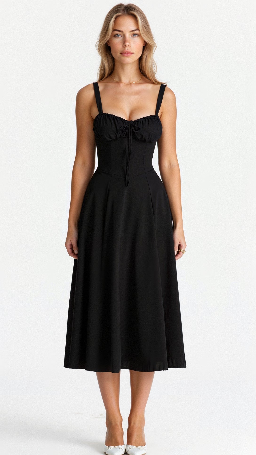 A woman wearing a midi dress with a fitted bodice and a flowing skirt, suitable for a wedding. The dress features a corset-style top and 2