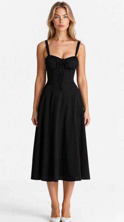 A woman wearing a midi dress with a fitted bodice and a flowing skirt, suitable for a wedding. The dress features a corset-style top and 2