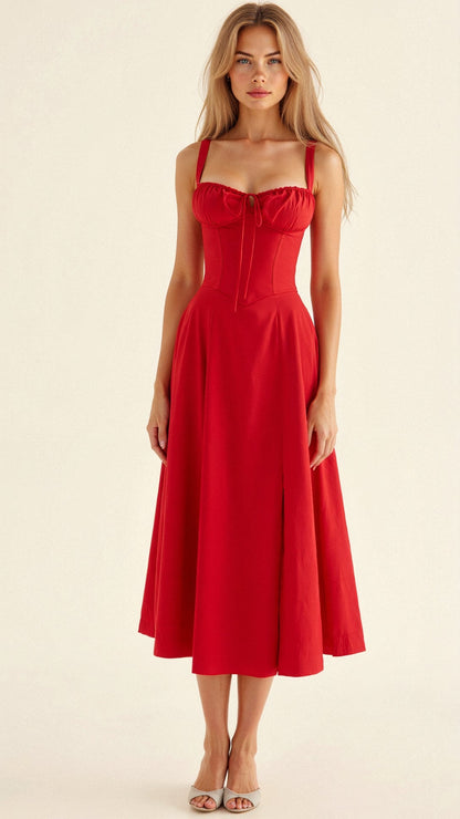 A woman wearing a midi dress with a fitted bodice and a flowing skirt, suitable for a wedding. The dress features a corset-style top and 9