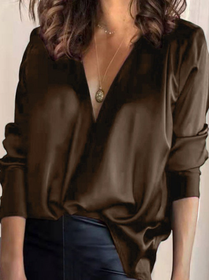 Elegant women's blouse with a V-neck and long sleeves, featuring a fitted design and subtle detailing. 5