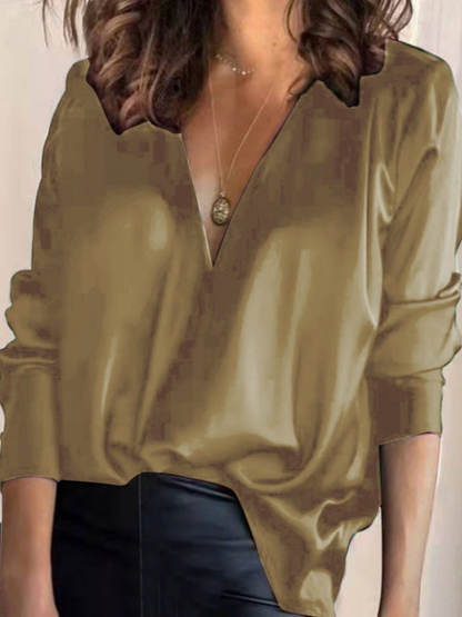 Elegant women's blouse with a V-neck and long sleeves, featuring a fitted design and subtle detailing. 7
