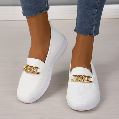 Women's knit shoes featuring a gold chain detail and a white sole. 1