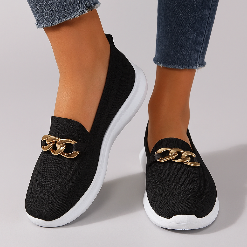 Women's knit shoes featuring a gold chain detail and a white sole. 2