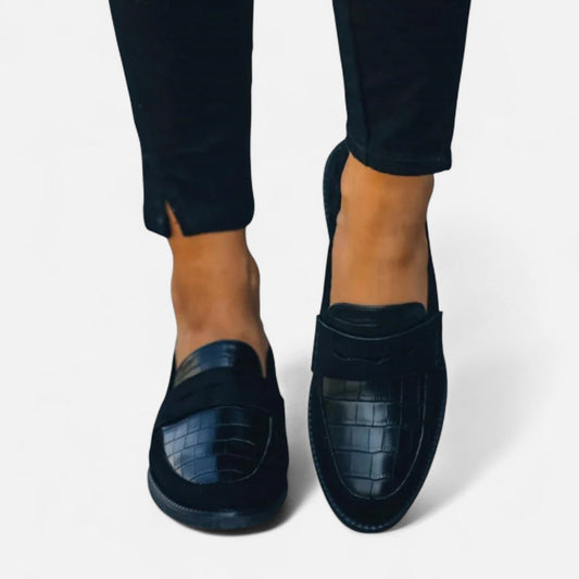 Women's leather loafers featuring a classic design, showcasing a sleek silhouette and minimalistic style. 0