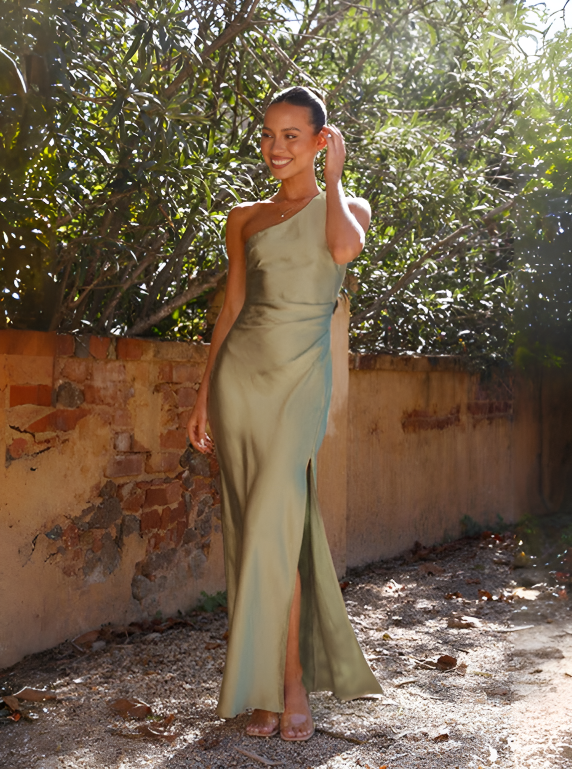 Asymmetrical maxi dress with exposed shoulder, featuring a flowing design suitable for formal events. 2