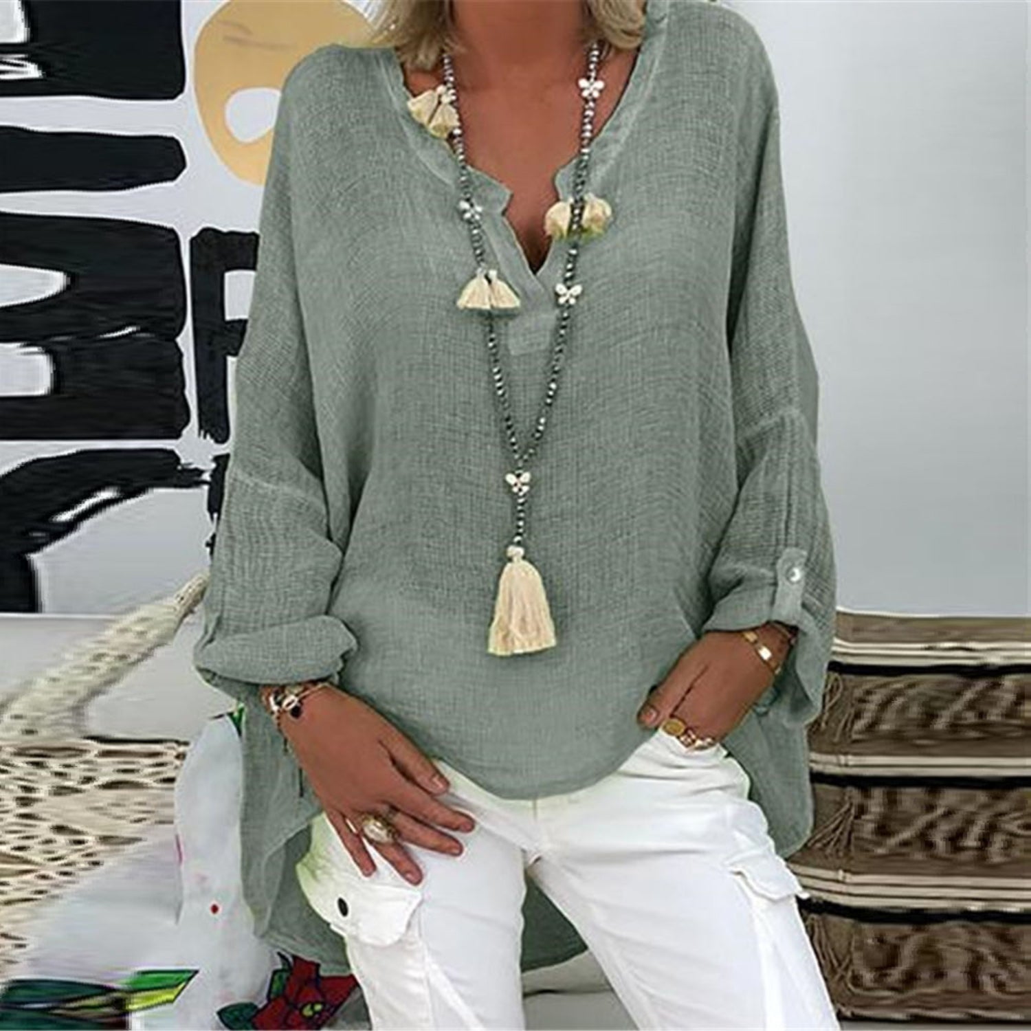 A women's summer blouse featuring a feminine cut, displayed on a mannequin in a simple setting. 0