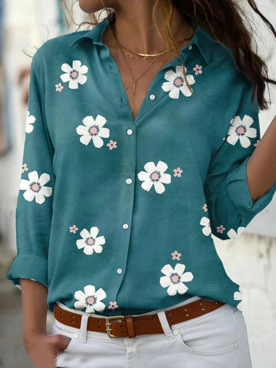 A women's summer blouse featuring a floral pattern and long sleeves, displayed on a mannequin. 3