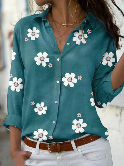A women's summer blouse featuring a floral pattern and long sleeves, displayed on a mannequin. 3