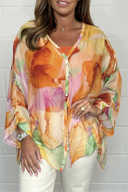 Loose-fitting women's summer blouse displayed on a mannequin, featuring short sleeves and a relaxed silhouette. 0