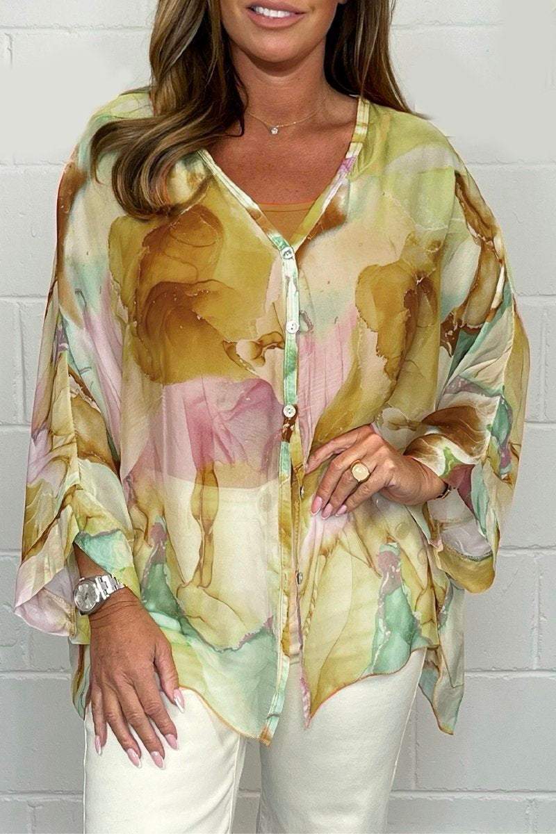Loose-fitting women's summer blouse displayed on a mannequin, featuring short sleeves and a relaxed silhouette. 1