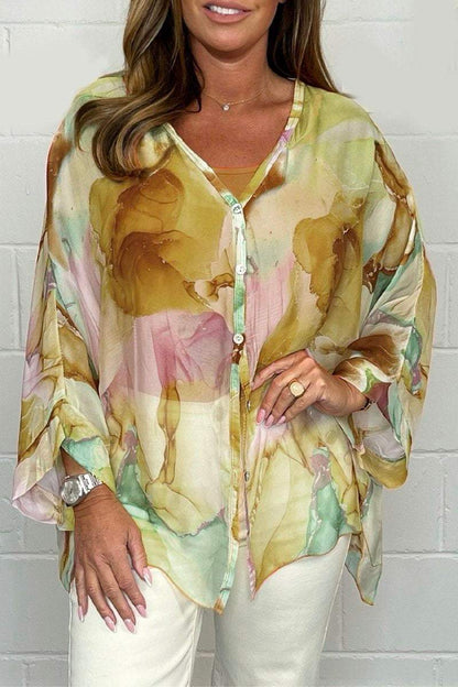 Loose-fitting women's summer blouse displayed on a mannequin, featuring short sleeves and a relaxed silhouette. 1