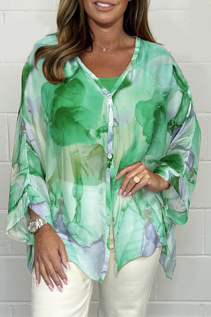 Loose-fitting women's summer blouse displayed on a mannequin, featuring short sleeves and a relaxed silhouette. 4