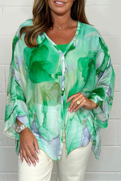 Loose-fitting women's summer blouse displayed on a mannequin, featuring short sleeves and a relaxed silhouette. 4