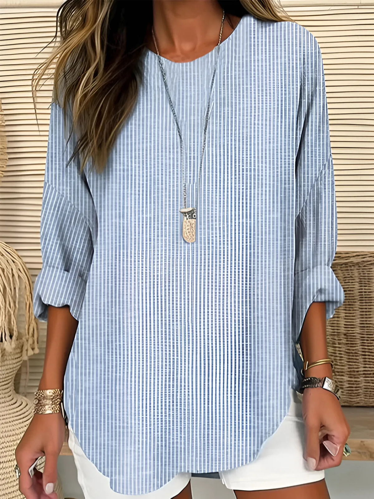 A women's long-sleeve blouse featuring vertical stripes, designed with an elegant and stylish look. 0