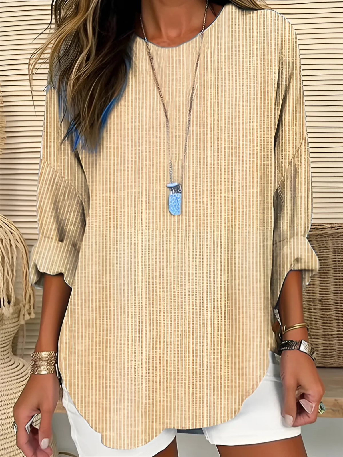 A women's long-sleeve blouse featuring vertical stripes, designed with an elegant and stylish look. 1