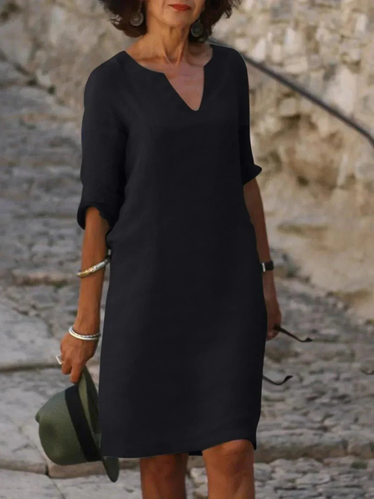 Women's black dress with three-quarter sleeves and a collar, featuring a simple and elegant design. 0