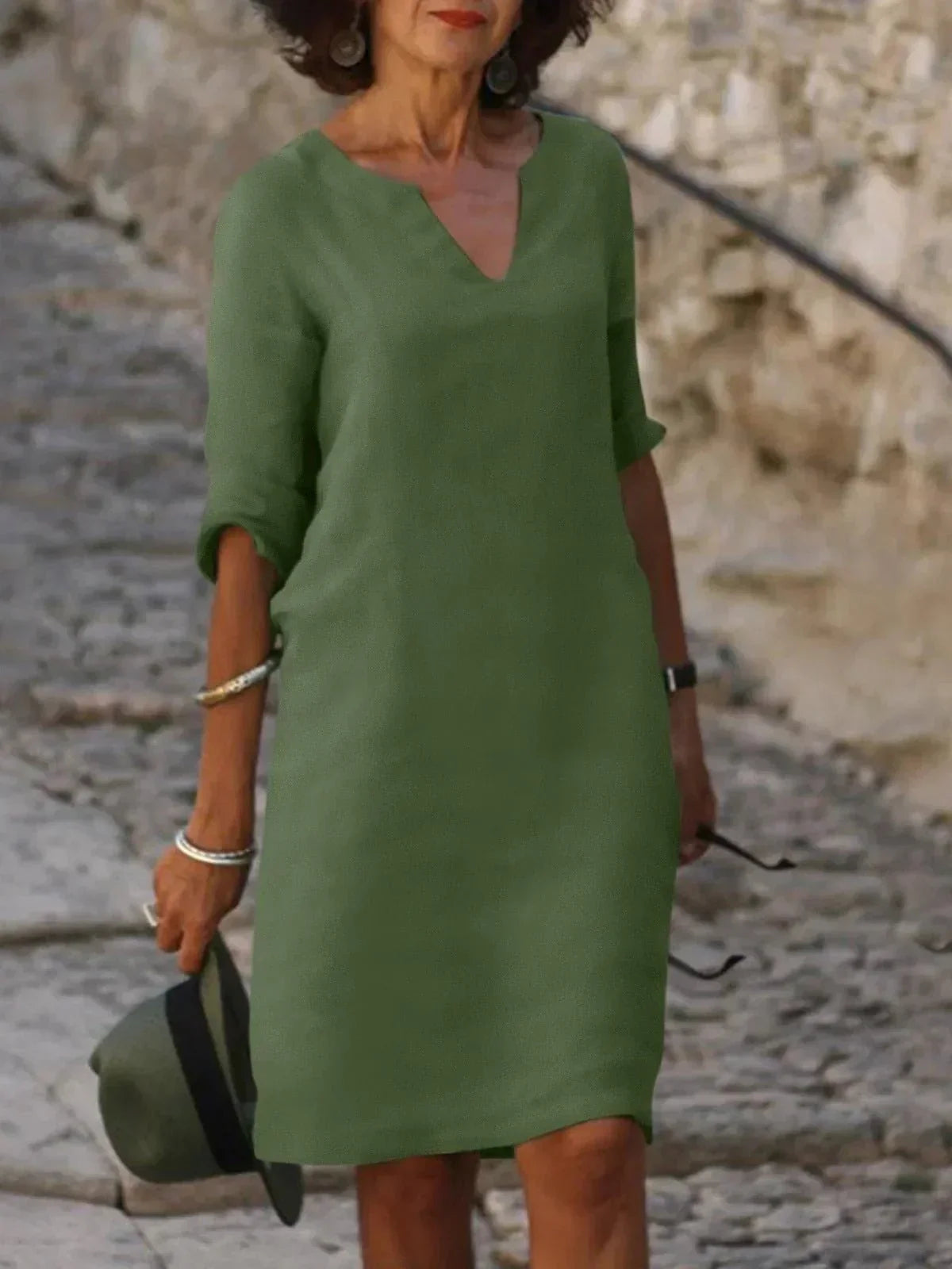 Women's black dress with three-quarter sleeves and a collar, featuring a simple and elegant design. 1