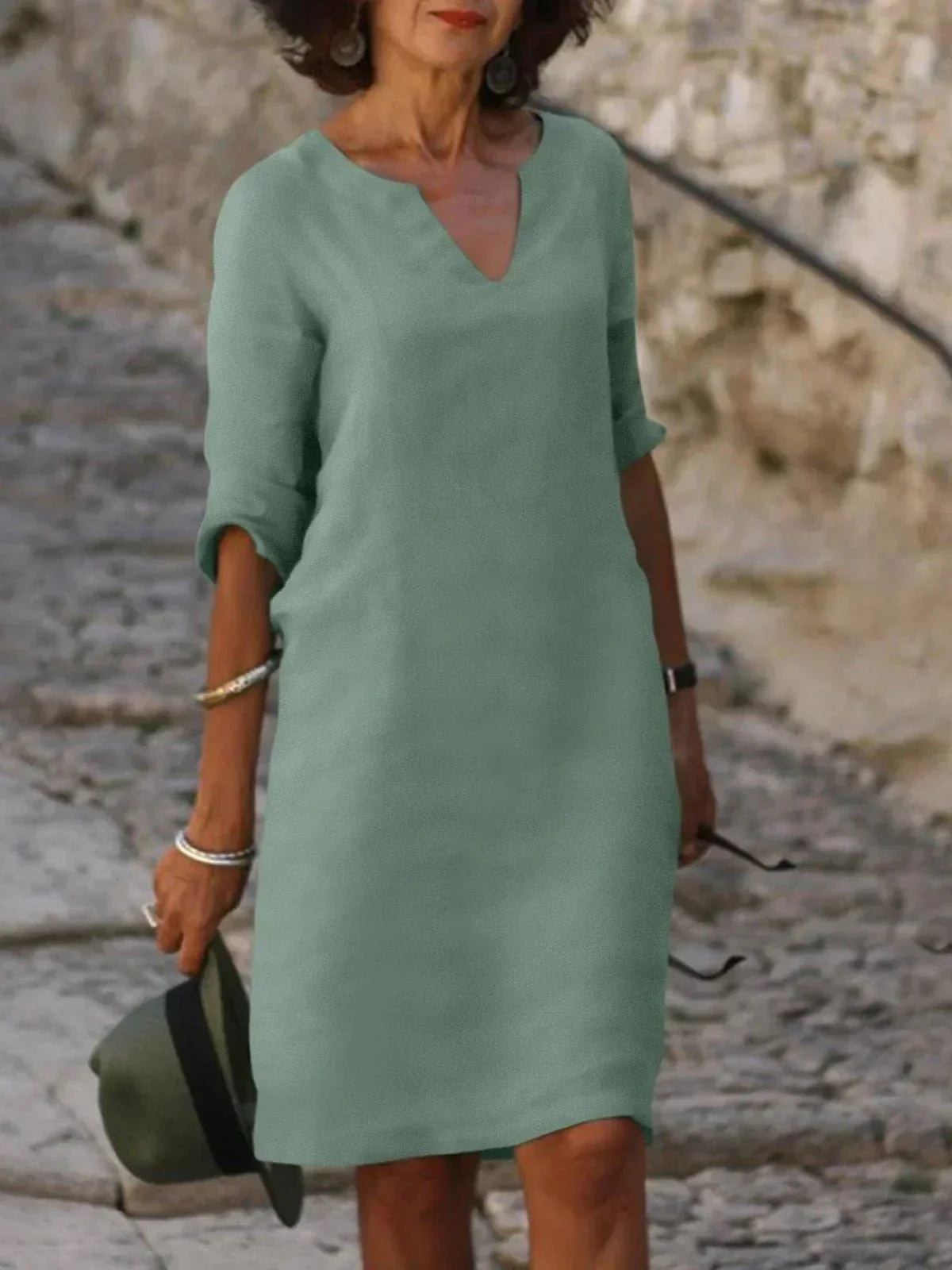 Women's black dress with three-quarter sleeves and a collar, featuring a simple and elegant design. 2