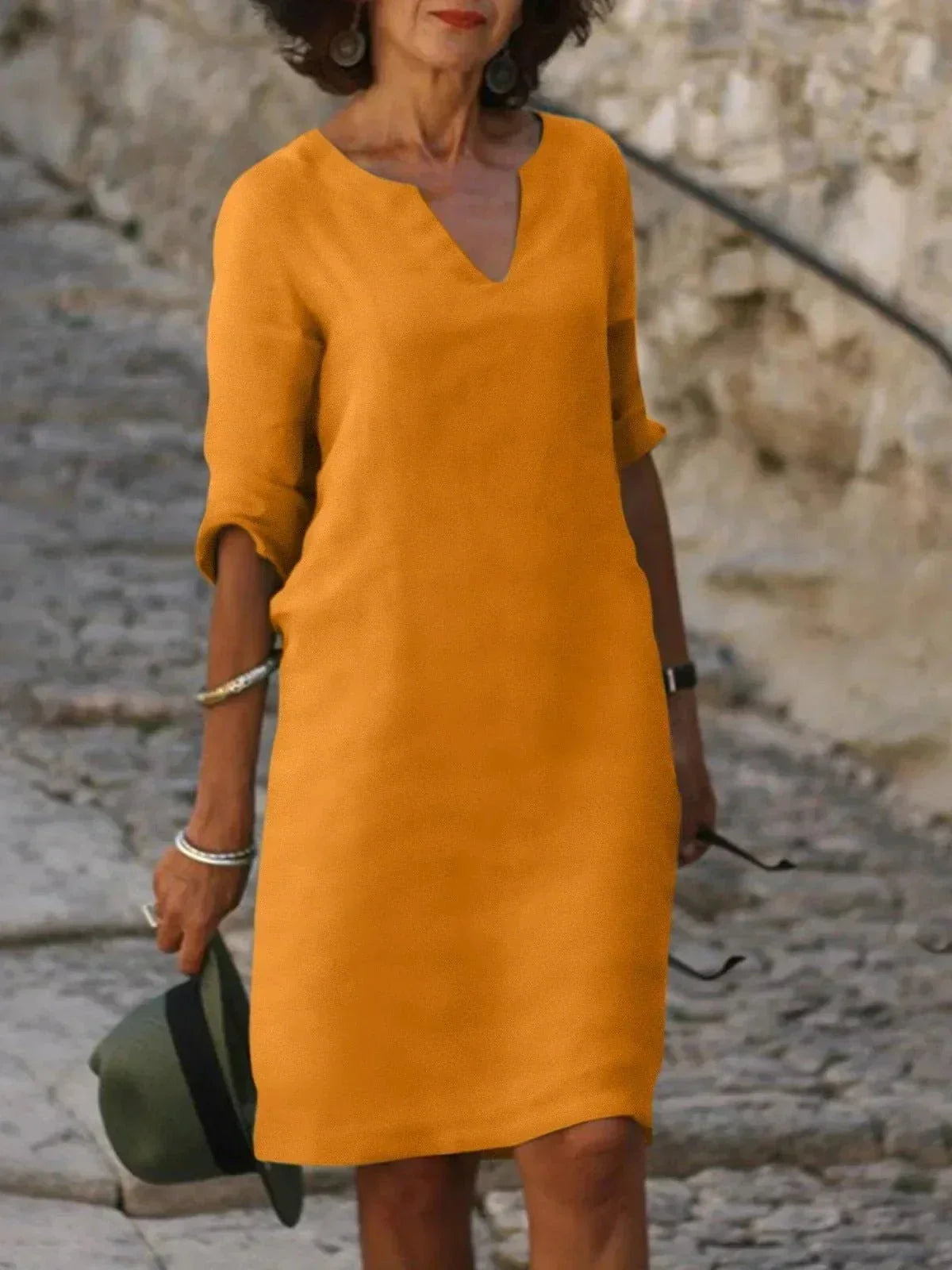 Women's black dress with three-quarter sleeves and a collar, featuring a simple and elegant design. 3