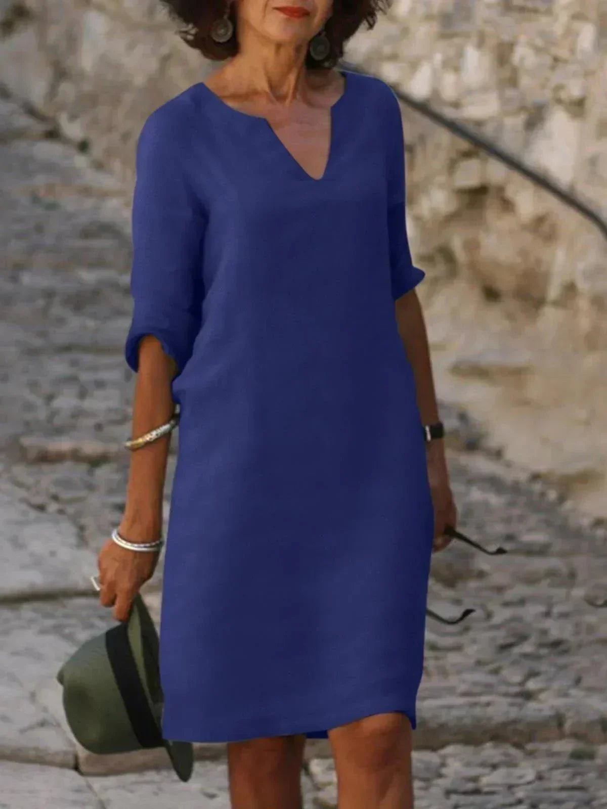 Women's black dress with three-quarter sleeves and a collar, featuring a simple and elegant design. 6