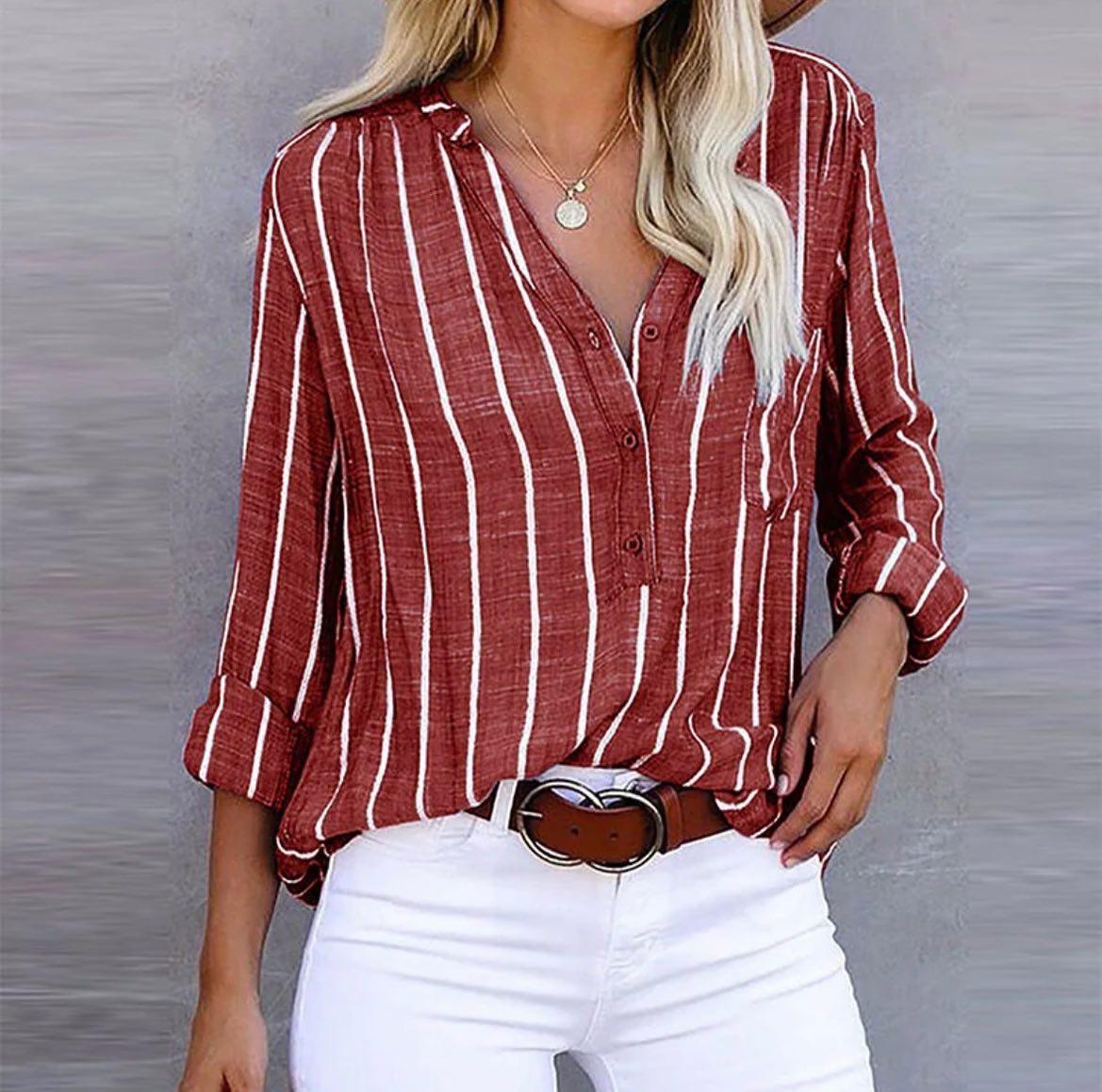 A loose-fitting women's summer blouse featuring a striped pattern. The blouse has short sleeves and a relaxed silhouette, suitable for casual wear. 1
