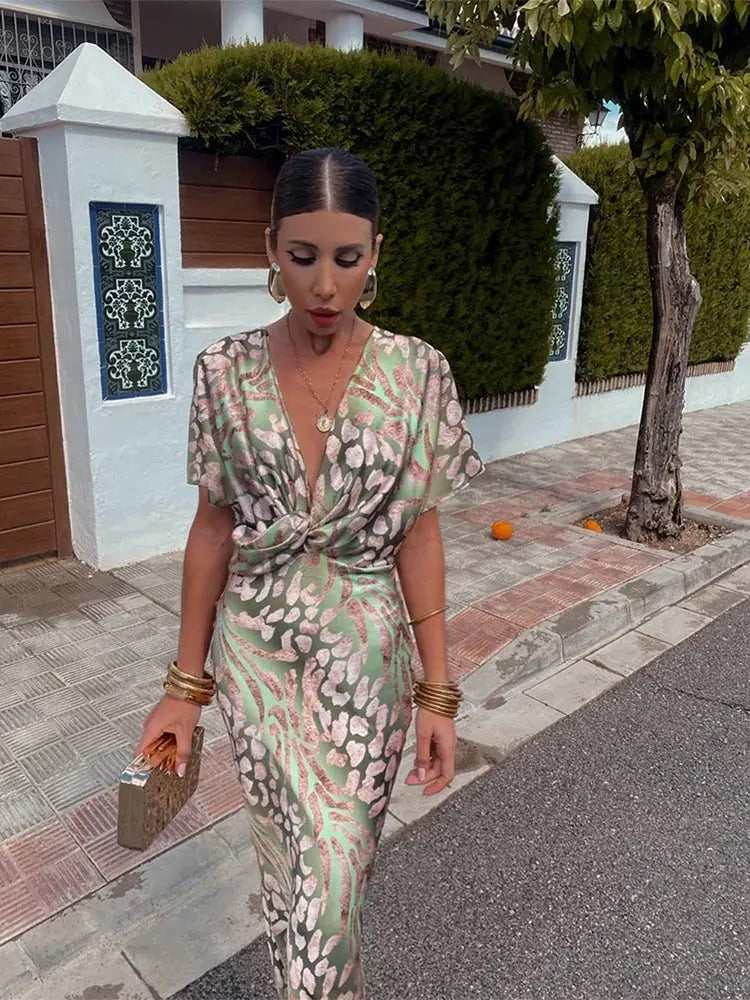 A midi dress with a V-neckline, featuring a wrap design, suitable for weddings and summer evenings. 0