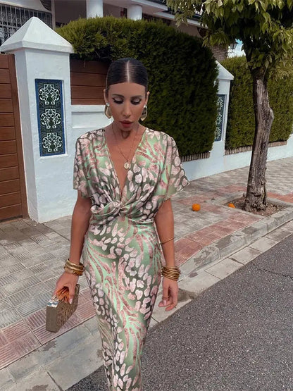 A midi dress with a V-neckline, featuring a wrap design, suitable for weddings and summer evenings. 0