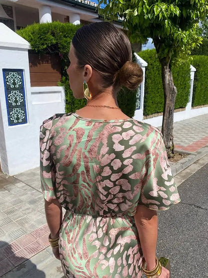 A midi dress with a V-neckline, featuring a wrap design, suitable for weddings and summer evenings. 3