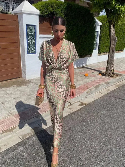 A midi dress with a V-neckline, featuring a wrap design, suitable for weddings and summer evenings. 5