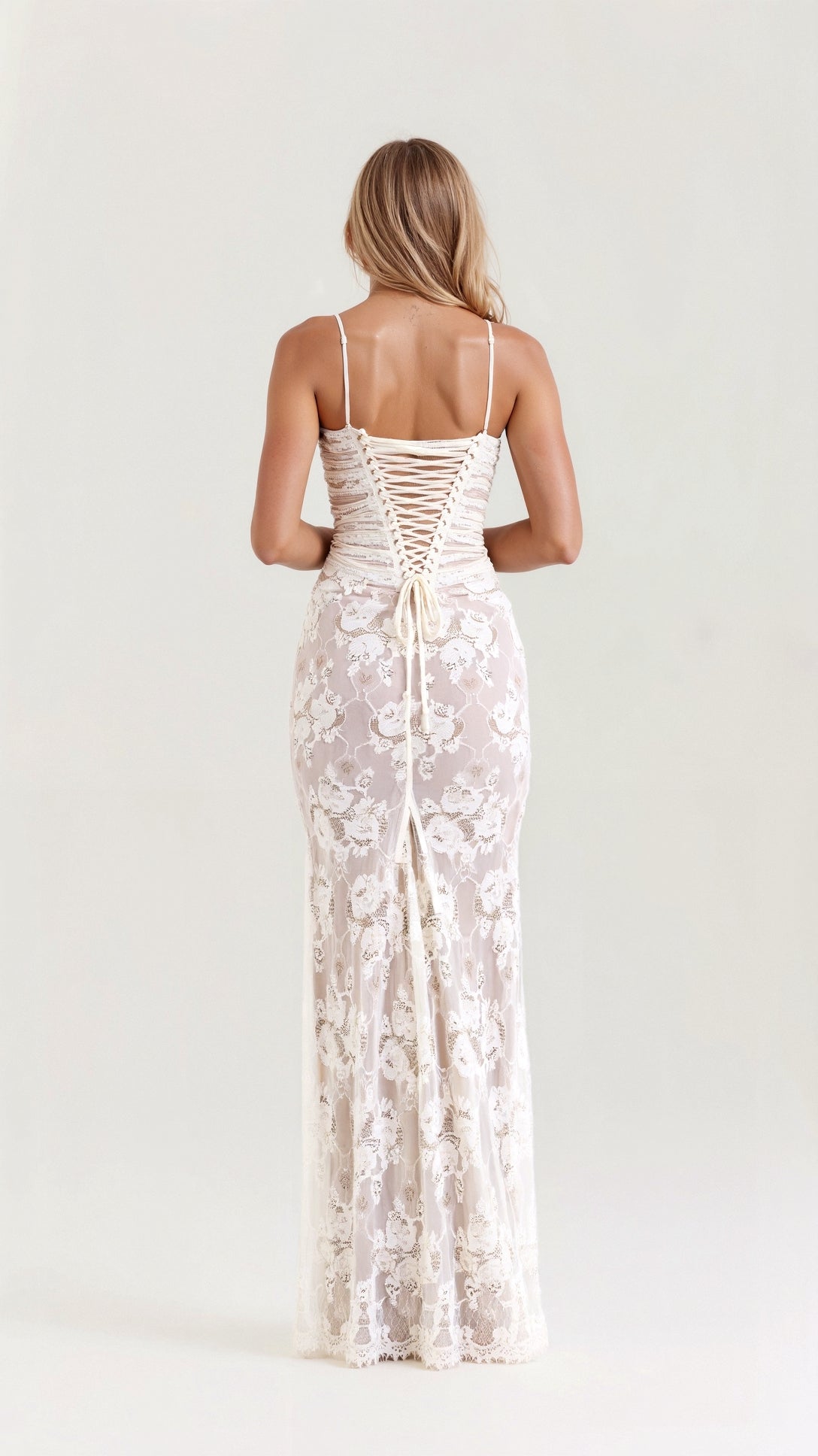 A long, floral-patterned dress with a corset-style bodice, designed for formal events such as weddings. The dress features lace details and a 2