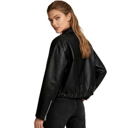 Short oversized bomber jacket for women made of faux leather, featuring a zippered front and ribbed cuffs. The jacket has a relaxed fit and a stylish 2