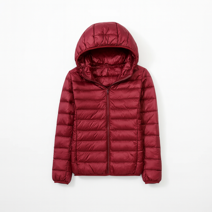 Women's puffer jacket with a hood, designed for cold weather, featuring a zip closure and side pockets. 15