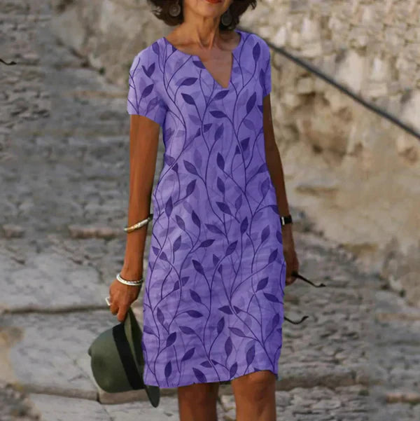 A casual women's summer dress featuring a loose fit and round neckline, displayed on a mannequin against a neutral background. 2