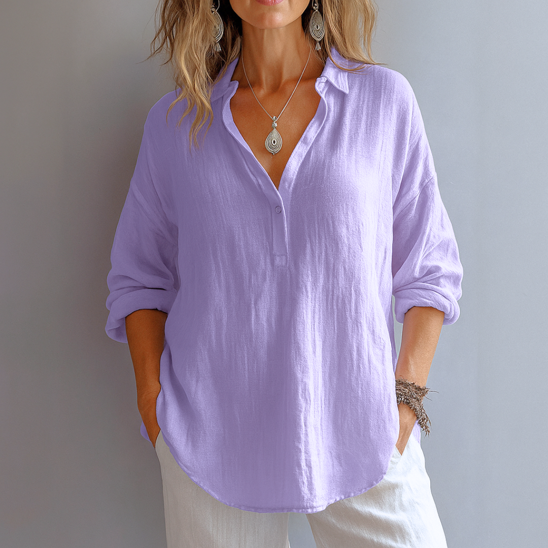 Loose women's shirt with a collar, featuring a relaxed fit and button-up front, displayed on a hanger against a neutral background. 3