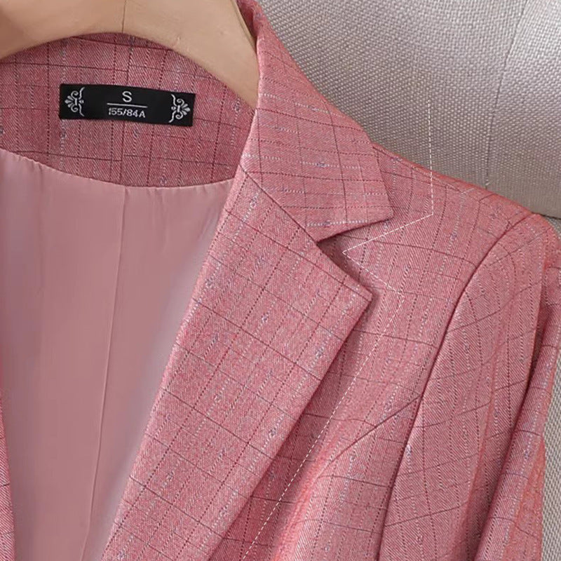 Women's fitted plaid blazer with elegant detailing. 1