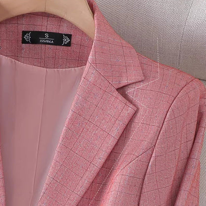 Women's fitted plaid blazer with elegant detailing. 1