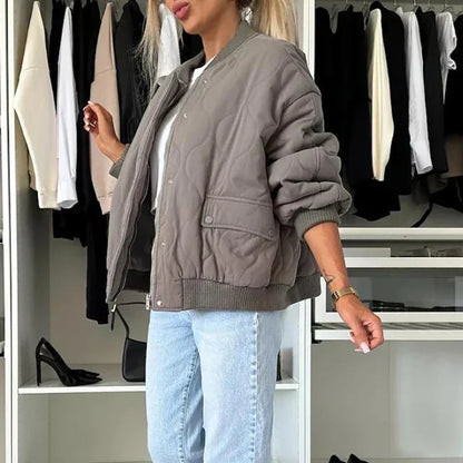 A women's quilted bomber jacket featuring a zip closure, displayed on a mannequin against a neutral background. 5