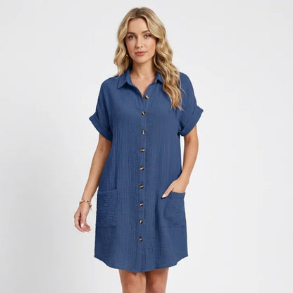 Dresses | A short-sleeved shirt dress featuring a button-down front and side pockets, designed for summer wear. 1